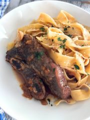 Red Wine Braised Short Ribs in a White plate with pasta