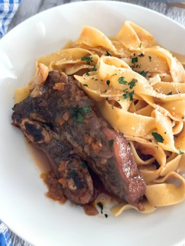 Red Wine Braised Short Ribs in a White plate with pasta