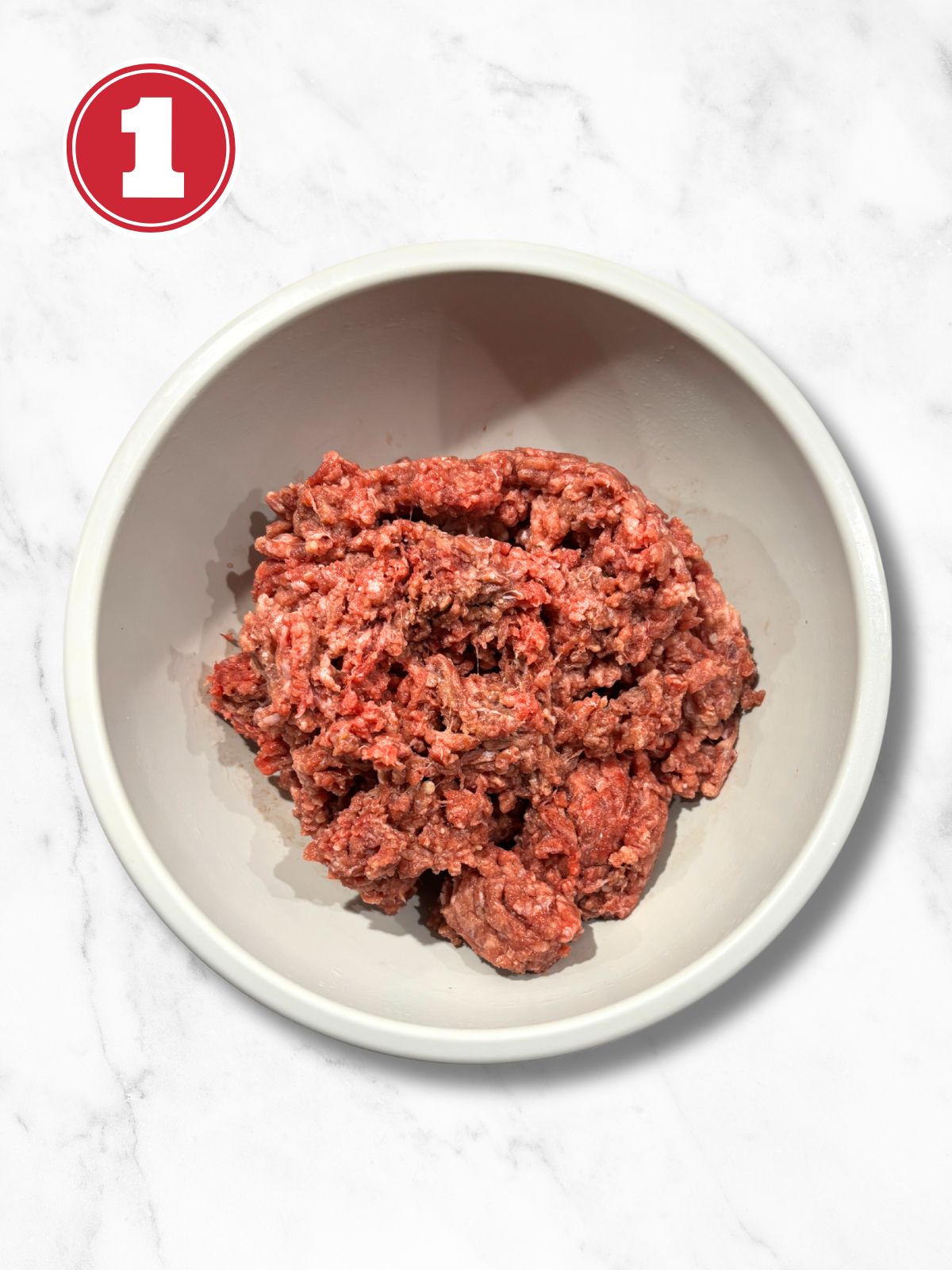 raw ground beef in a grey bowl