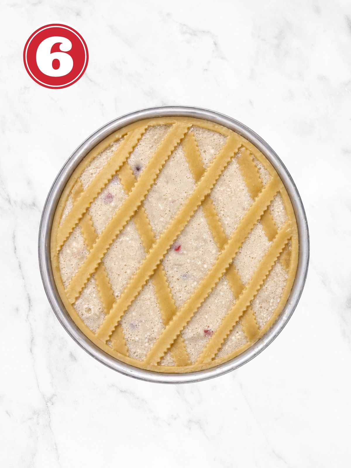 Placing pasta on raw pastiera Napolitana to make a lattice